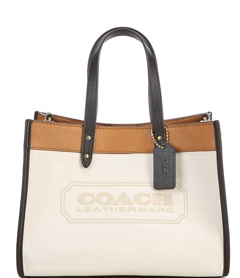 who buys coach bags